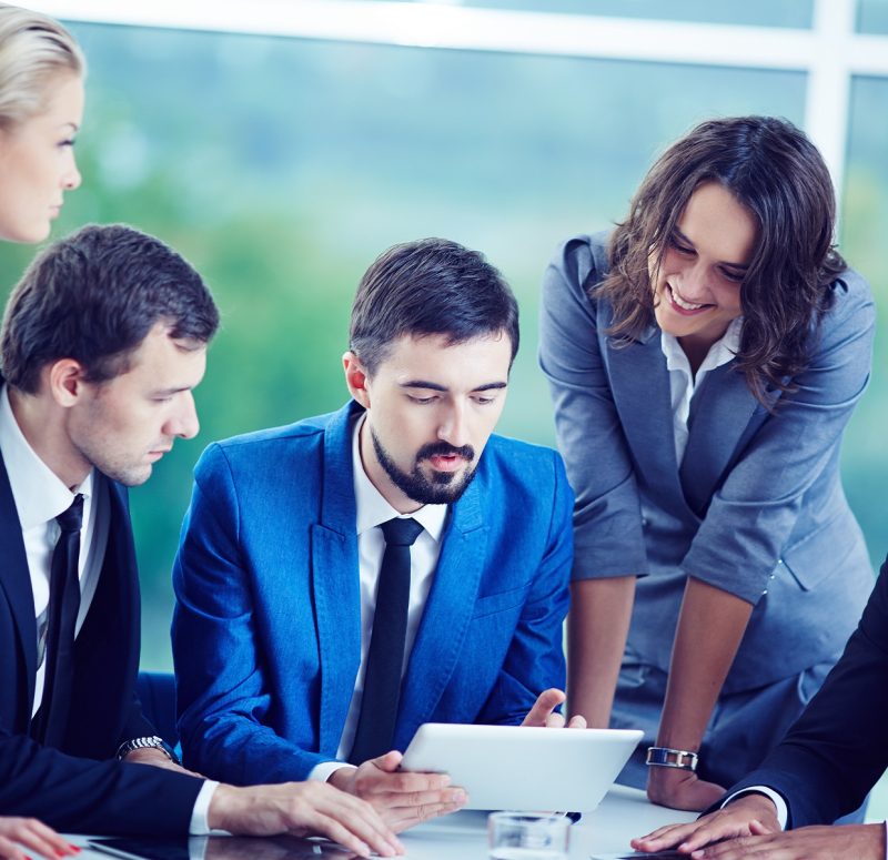 Several confident employees gathered at workplace discussing data
