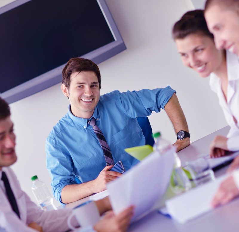 Group of happy young  business people in a meeting at office